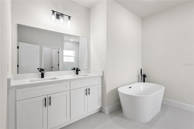 bathroom with a bathtub, tile patterned flooring, and vanity