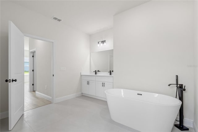 bathroom featuring a washtub and vanity