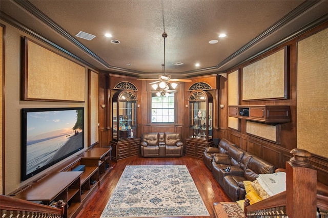 interior space featuring crown molding, ceiling fan, dark wood-type flooring, and a textured ceiling