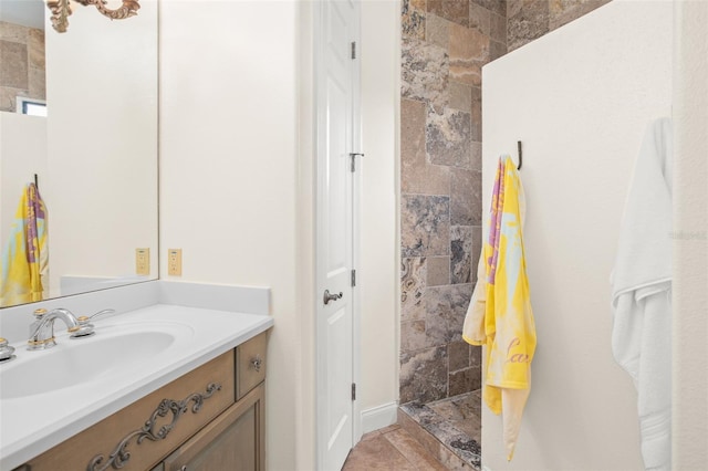 bathroom featuring vanity and tiled shower