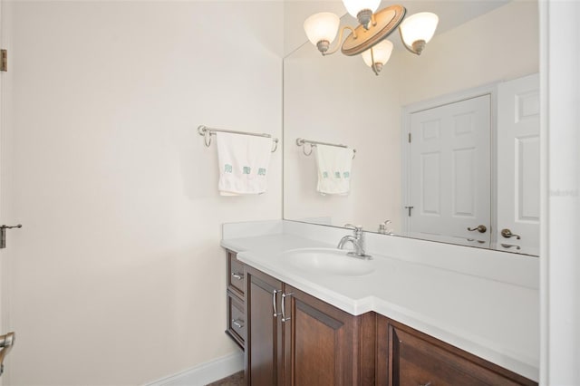 bathroom featuring an inviting chandelier and vanity