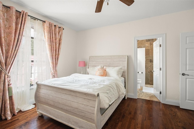 bedroom with ceiling fan, dark wood-type flooring, and ensuite bath