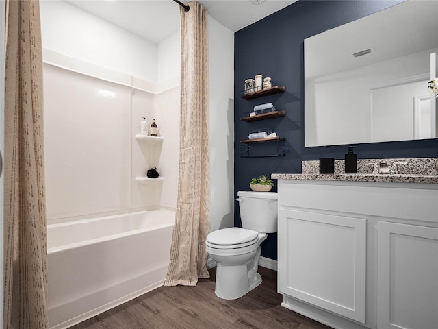 bathroom featuring toilet, shower / tub combo, wood finished floors, visible vents, and vanity