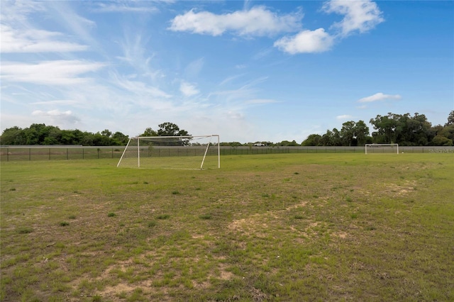 view of yard with fence and a rural view