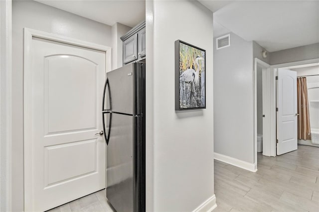 hallway featuring light tile patterned floors