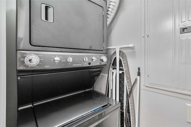 laundry room with stacked washer and dryer