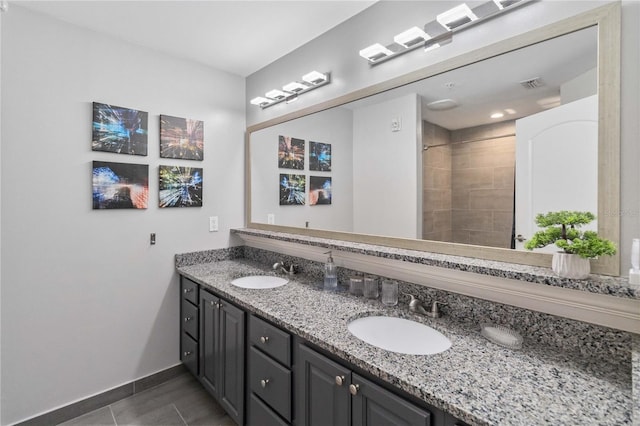 bathroom with dual vanity and tile patterned floors