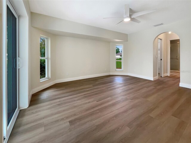 empty room with ceiling fan and hardwood / wood-style floors