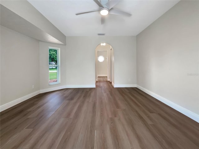 empty room featuring dark hardwood / wood-style floors and ceiling fan