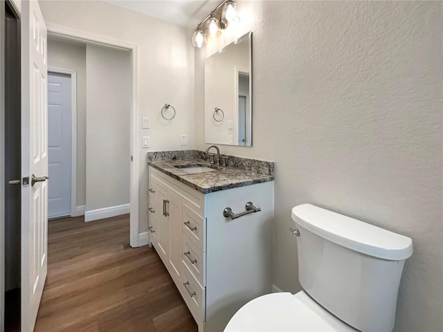 bathroom featuring vanity, toilet, and wood-type flooring