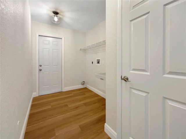 clothes washing area with hookup for a washing machine and light hardwood / wood-style floors