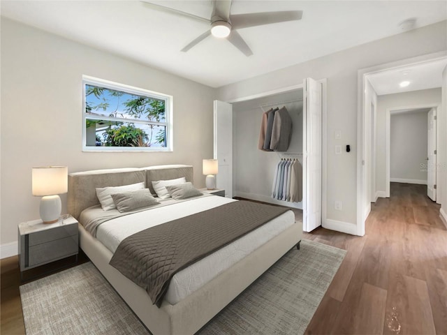 bedroom with wood-type flooring, a closet, and ceiling fan