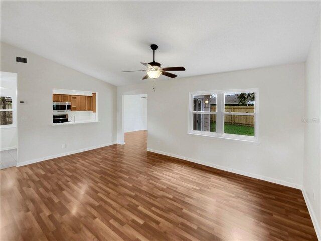 unfurnished living room with wood-type flooring, ceiling fan, and lofted ceiling