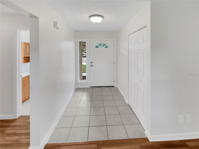 foyer featuring light hardwood / wood-style floors and a textured ceiling