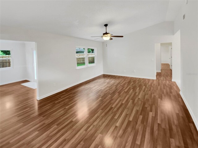 spare room with wood-type flooring, vaulted ceiling, and ceiling fan