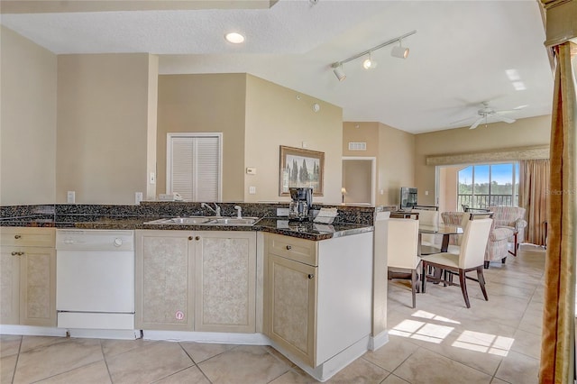 kitchen featuring ceiling fan, sink, light tile patterned flooring, and dishwashing machine