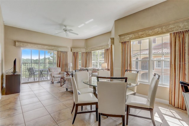 dining space featuring ceiling fan and light tile patterned flooring