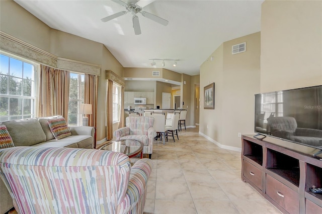 tiled living room with ceiling fan and track lighting