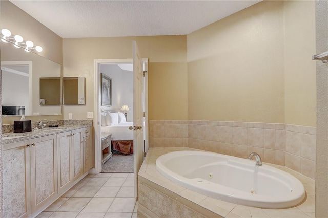 bathroom with a textured ceiling, vanity, and tile patterned flooring