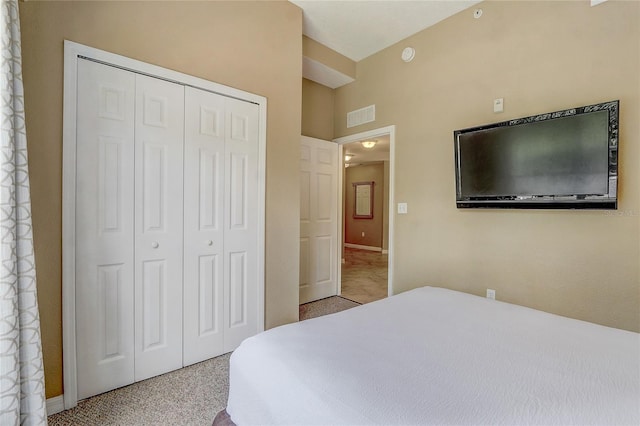 bedroom with light colored carpet and a closet