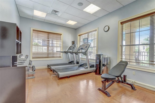 workout room with a drop ceiling