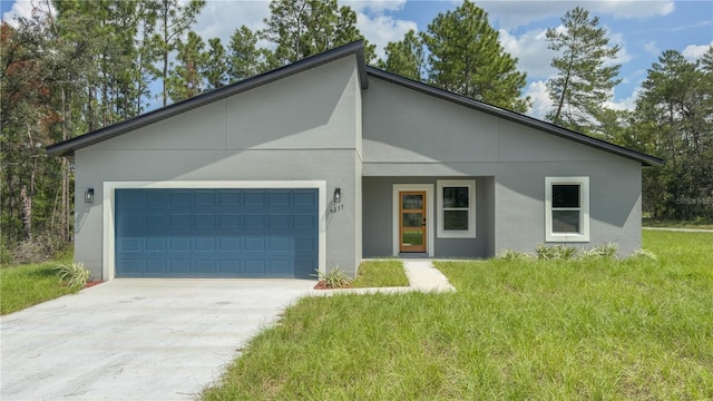 5277 SW 165th Street Rd, Ocala, FL 34473 - contemporary home with a garage, driveway, stucco siding, and a front yard