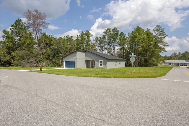 5277 SW 165th Street Rd, Ocala, FL 34473 - view of front of home featuring a front lawn, an attached garage, and stucco siding