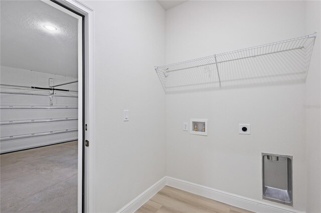 laundry room with hookup for a washing machine, hardwood / wood-style floors, and electric dryer hookup