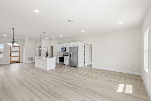 5277 SW 165th Street Rd, Ocala, FL 34473 - kitchen featuring stainless steel appliances, open floor plan, white cabinets, light wood-type flooring, and recessed lighting