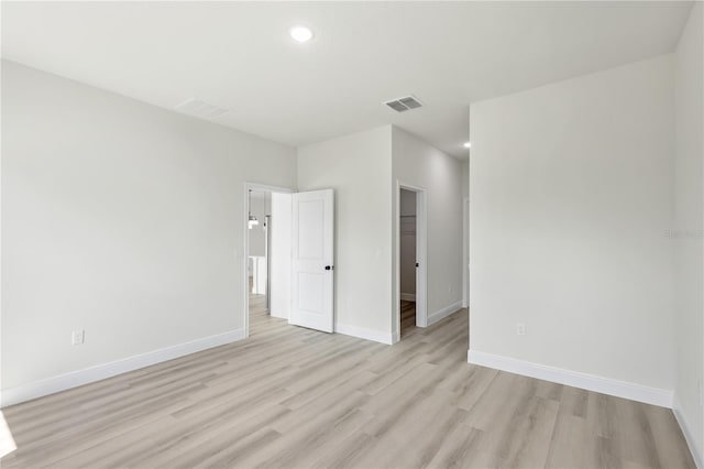 empty room with light hardwood / wood-style flooring