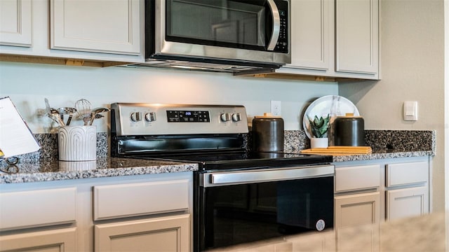 kitchen with stone counters and stainless steel appliances