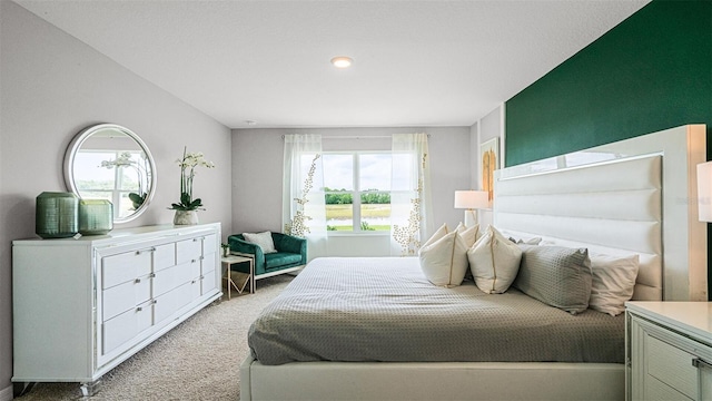 bedroom with multiple windows and light colored carpet