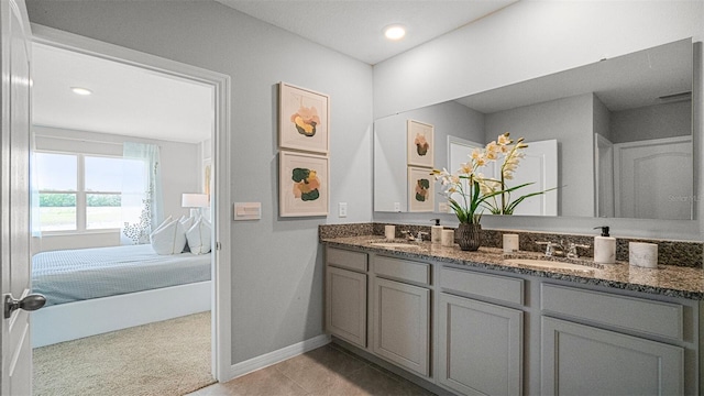 bathroom with dual vanity and tile patterned flooring