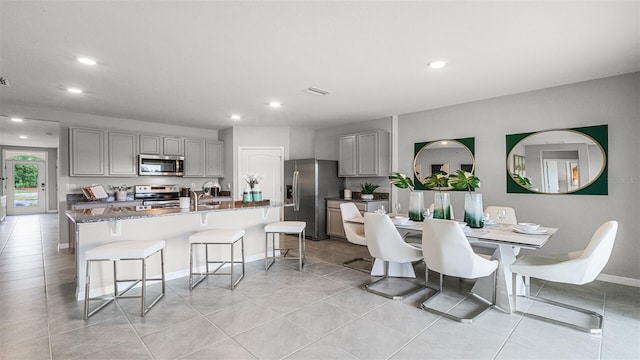 tiled dining area featuring sink