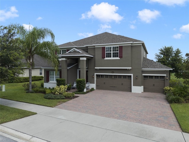 view of front of house featuring a front lawn and a garage