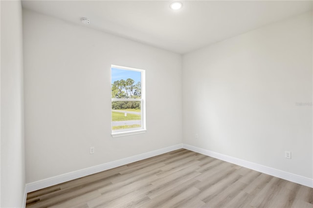 spare room with light hardwood / wood-style flooring