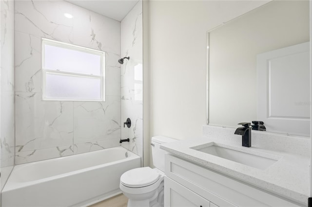 full bathroom with vanity, tiled shower / bath combo, and toilet