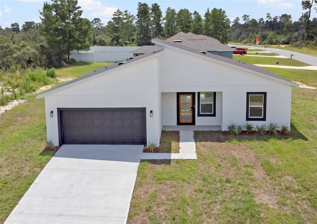 view of front of home with a front yard and a garage