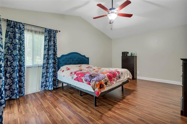 bedroom featuring wood-type flooring, vaulted ceiling, and ceiling fan