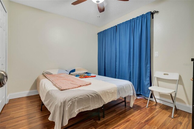 bedroom with ceiling fan and hardwood / wood-style flooring