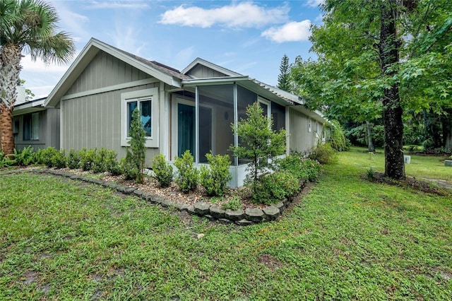 701 Castlewood Dr, Winter Springs, FL 32708 - view of property exterior with a sunroom and a yard