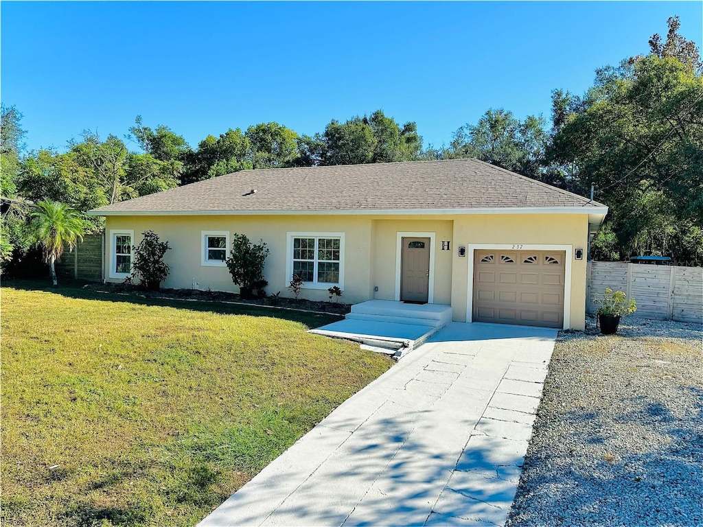 ranch-style house featuring stucco siding, an attached garage, a front yard, fence, and driveway