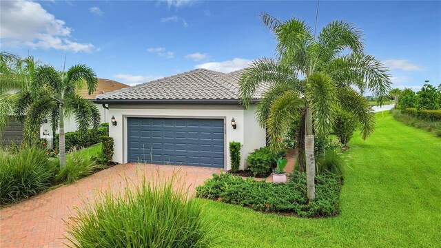 view of front of home with a garage and a front lawn