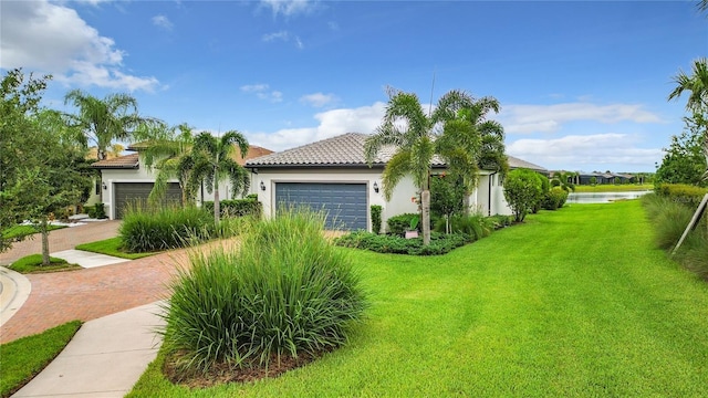 view of front facade with a garage and a front lawn