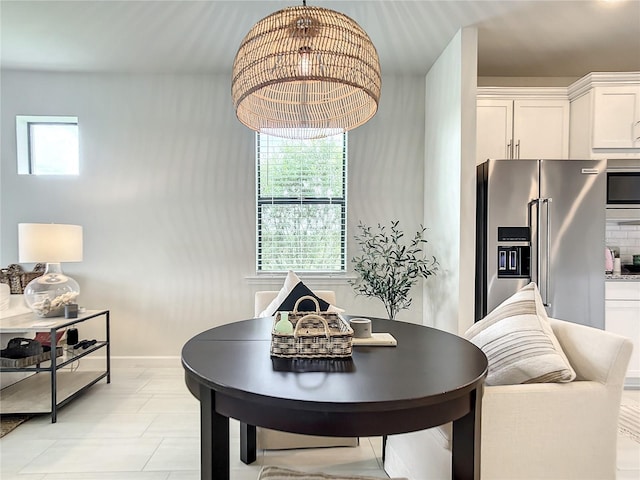 dining space featuring plenty of natural light and baseboards