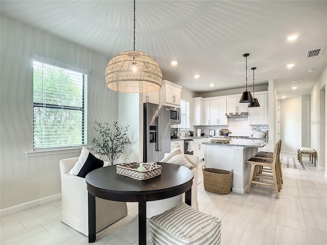 dining area featuring light tile patterned floors, recessed lighting, visible vents, and baseboards