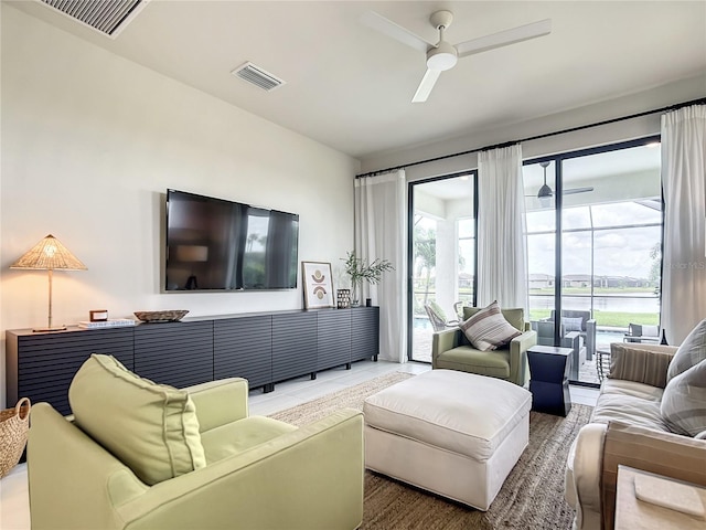 living area with visible vents and a ceiling fan