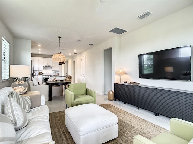 living room featuring visible vents and recessed lighting