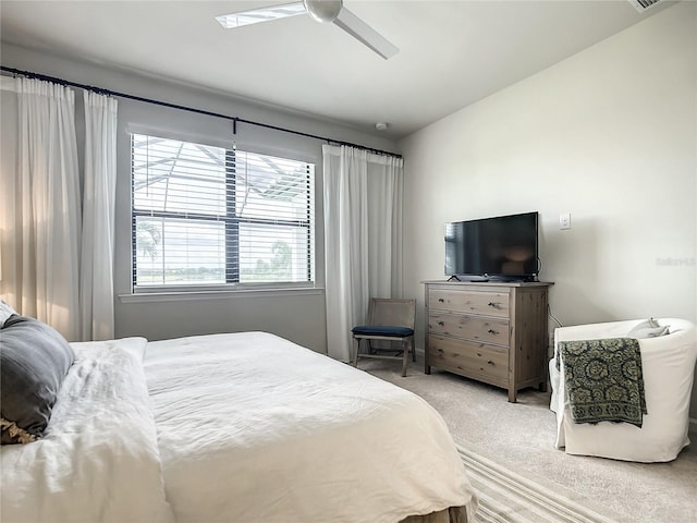 carpeted bedroom featuring lofted ceiling and a ceiling fan