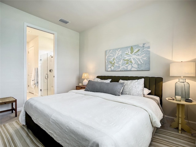 carpeted bedroom featuring visible vents, connected bathroom, and baseboards